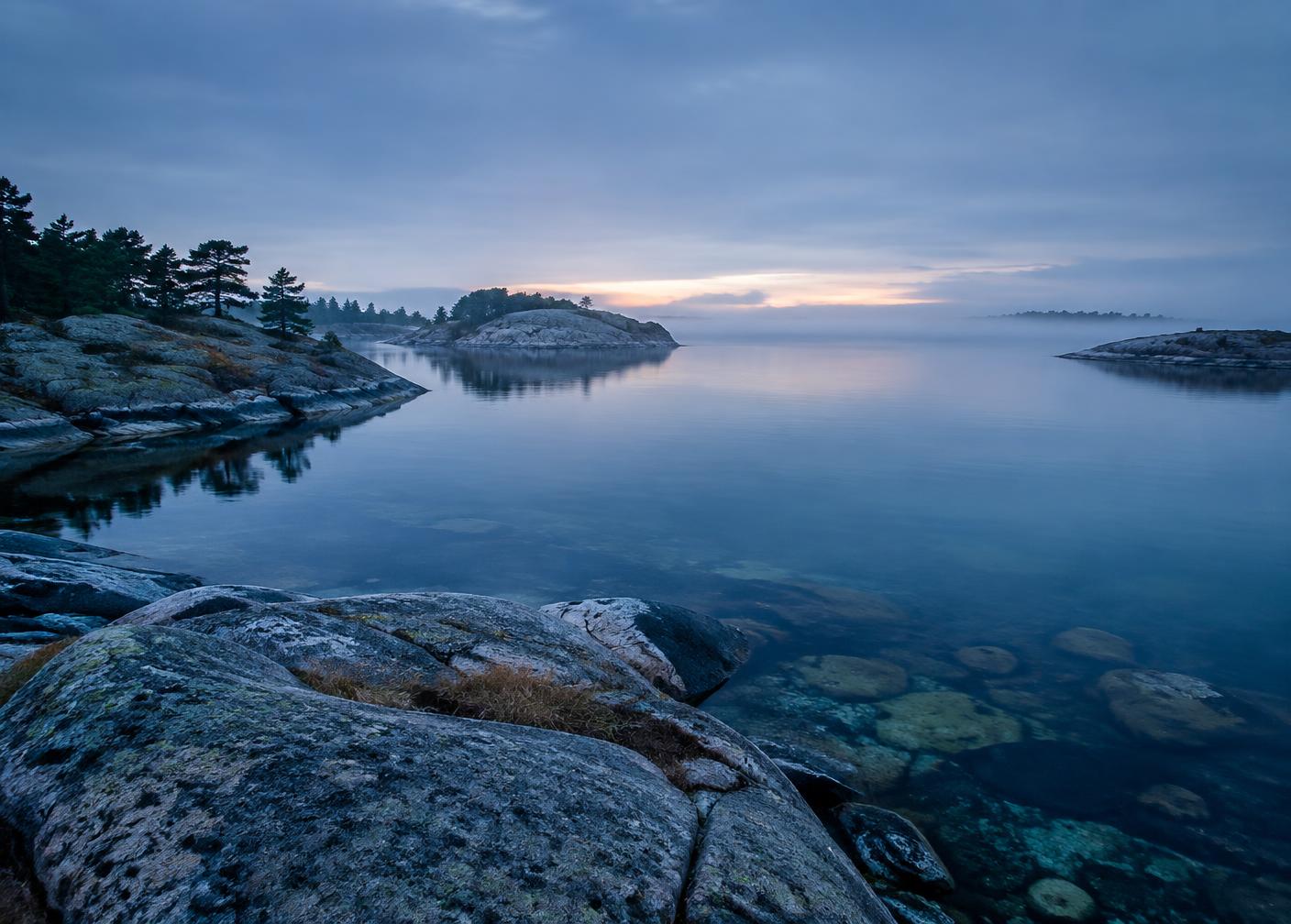 Clear Baltic water and rocky archipelago coastline at dawn